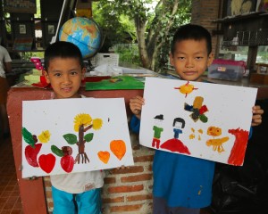 Some of our youngest students at Children's Shelter Foundation with their artworks.