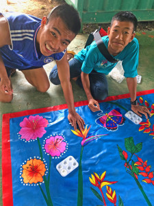 Young Thai students working on our mural