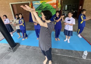 Ms. Grégoire rehearsing some students for the "Mae Ping" dance performance